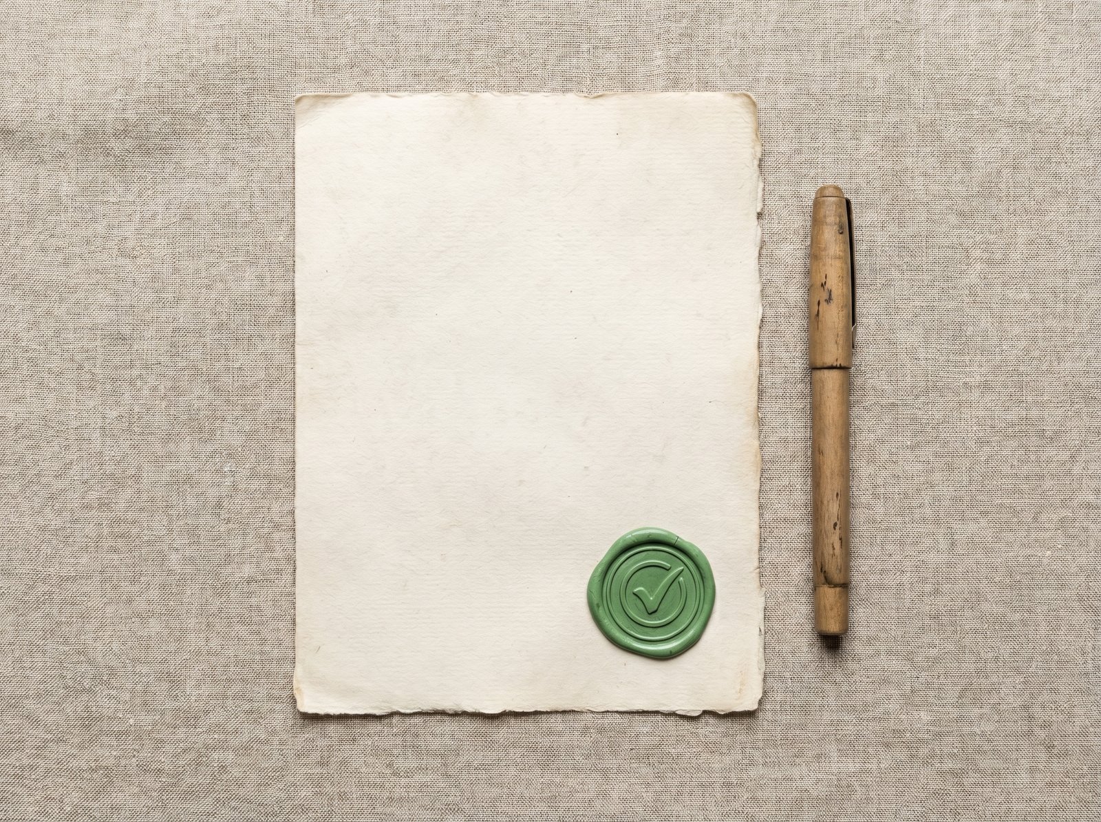 A stamped document and wooden pen representing an official notice